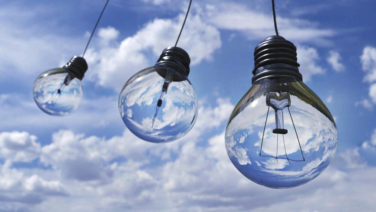 lightbulbs set against a blue cloudy sky